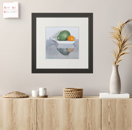 Framed still life print showing wheelbarrow with green and orange peppers in metal tray